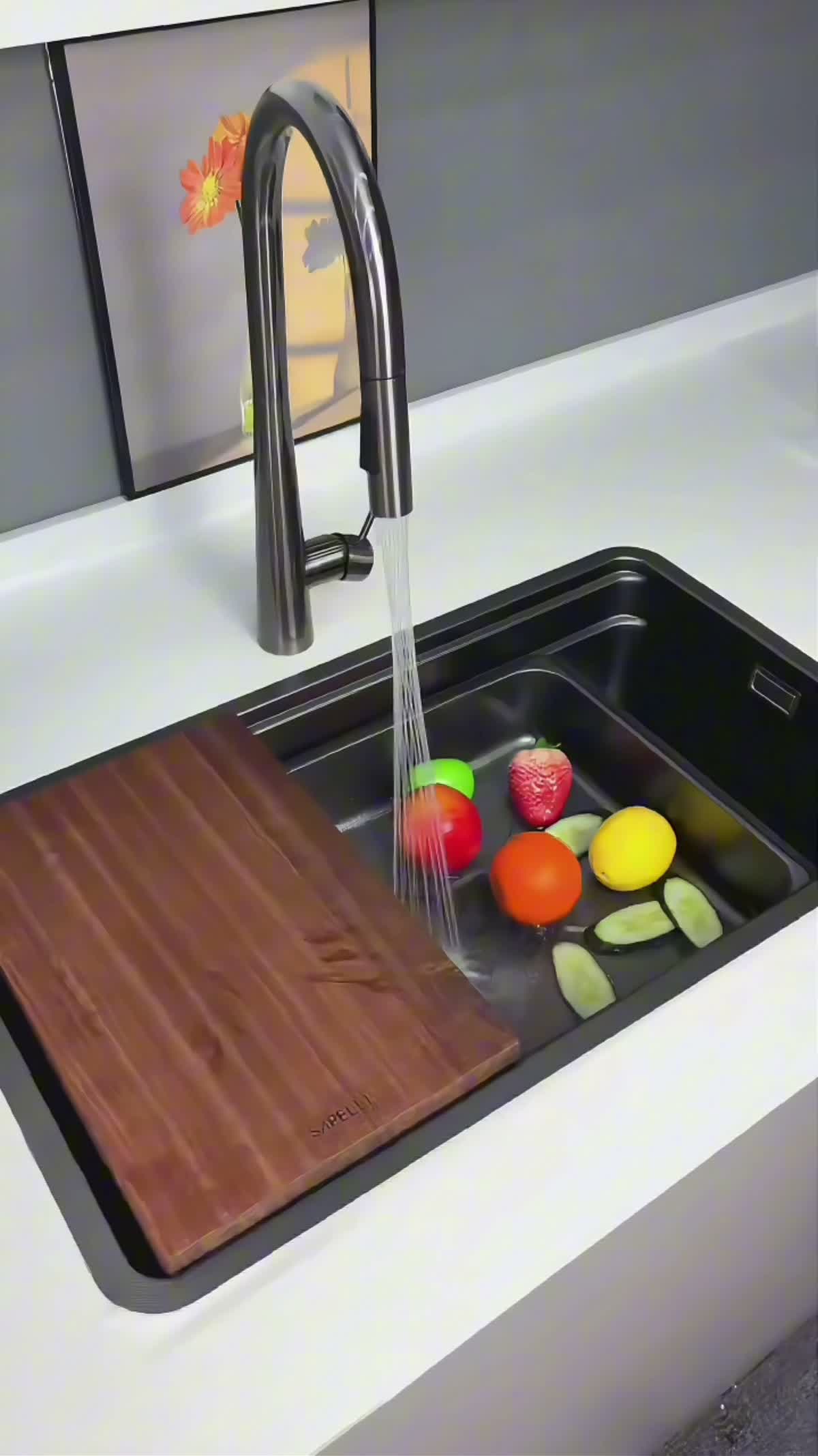 Model 7548 black workstation sink with sliding cutting board, removable draining accessories and dark faucet