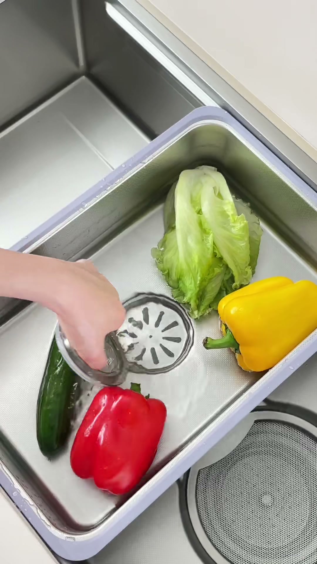 Removable inner basin used to rinse vegetables inside the workstation sink